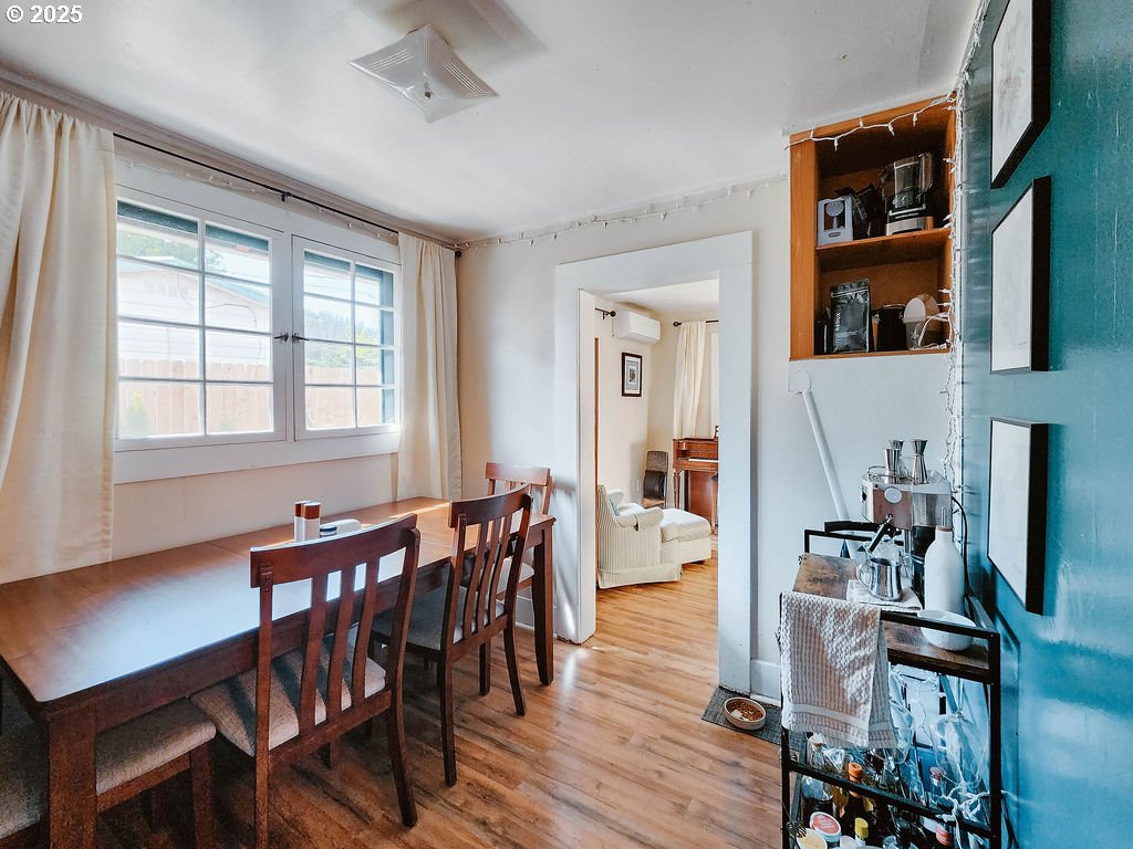 1895 City View Street Eugene, OR 97405 - Photo 9 of 36 a view of a a dining room with furniture window and wooden floor