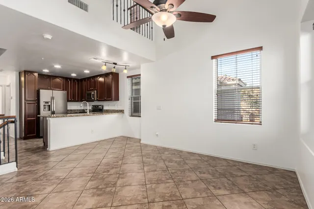 a view of kitchen with refrigerator and window
