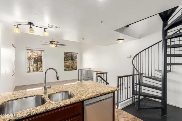 a kitchen with sink and mirror