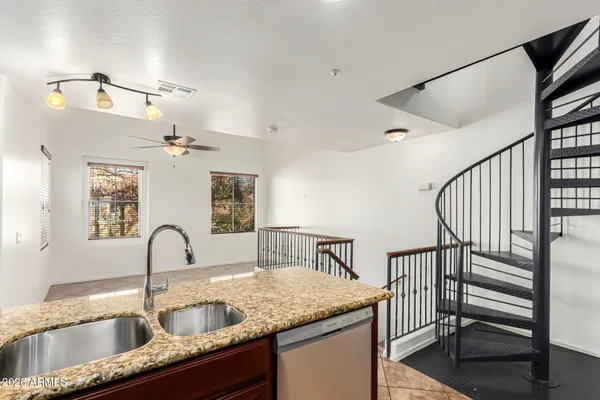 a kitchen with sink and mirror