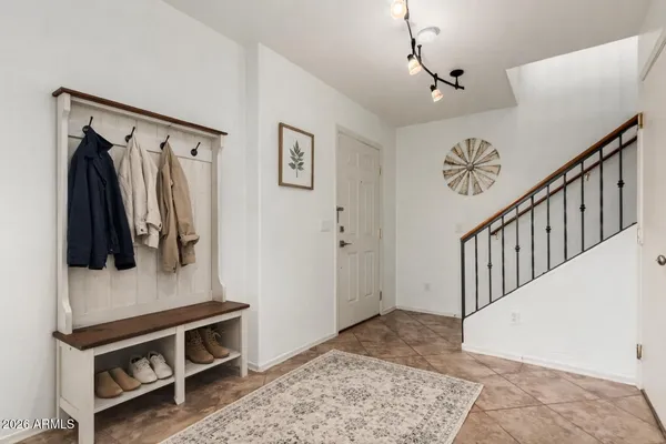 a view of a hallway with wooden floor and windows