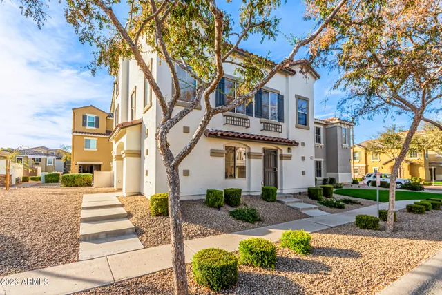 a front view of a building with tree s