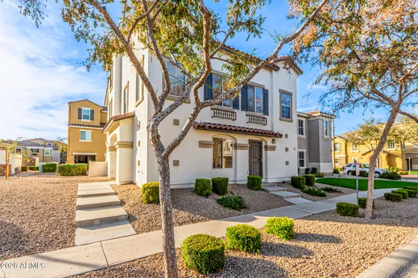a front view of a building with tree s
