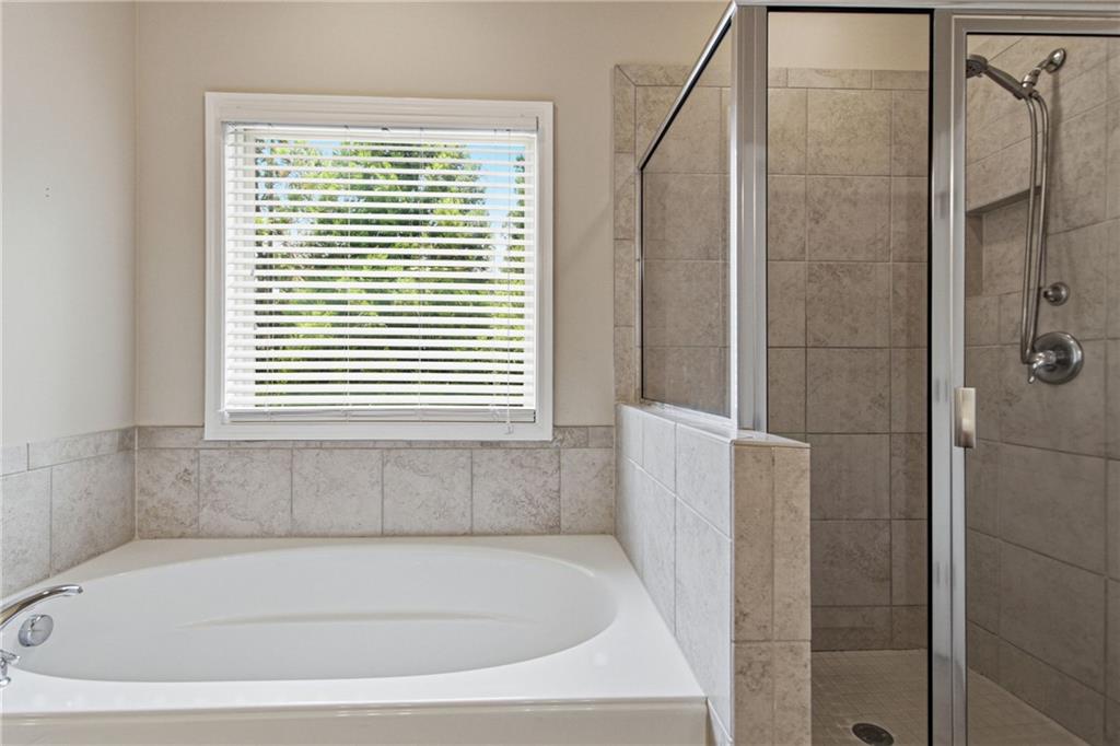114 Madison Street Canton, GA 30115 - Photo 30 of 39 a white bath tub sitting next to a window