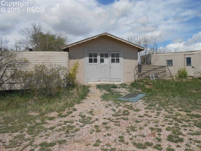 8860 Ermel Road Fountain, CO 80817 - Photo 2 of 5 single car garage with paint building, and compressor
