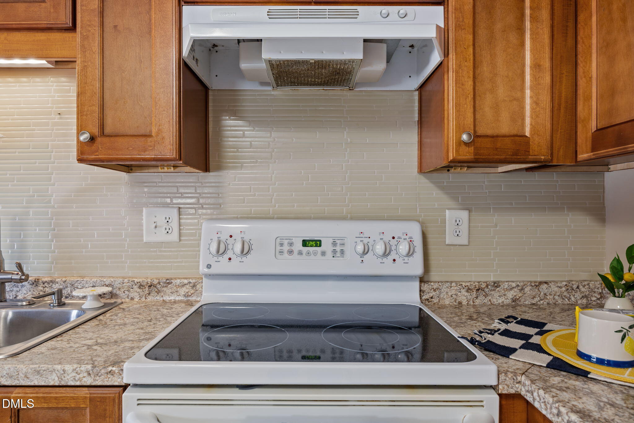 209 Weston Road Garner, NC 27529 - Photo 6 of 37 a kitchen with granite countertop stainless steel appliances stove and cabinets