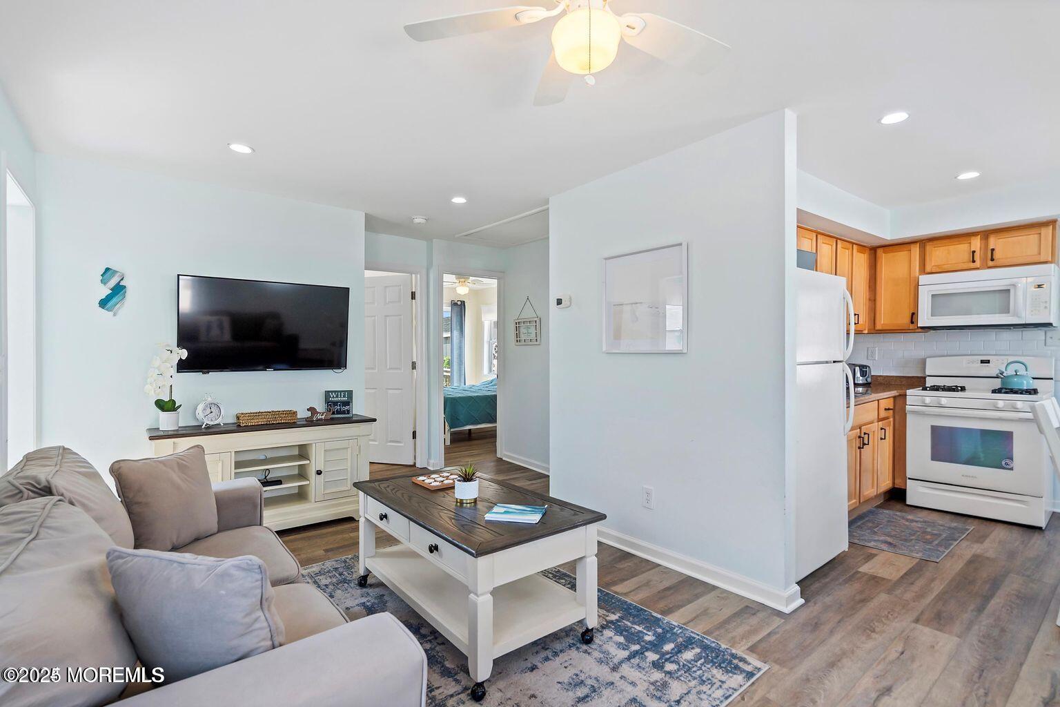 115-117 Coolidge Avenue Seaside Heights, NJ 08751 - Photo 12 of 25 a living room with furniture and a flat screen tv