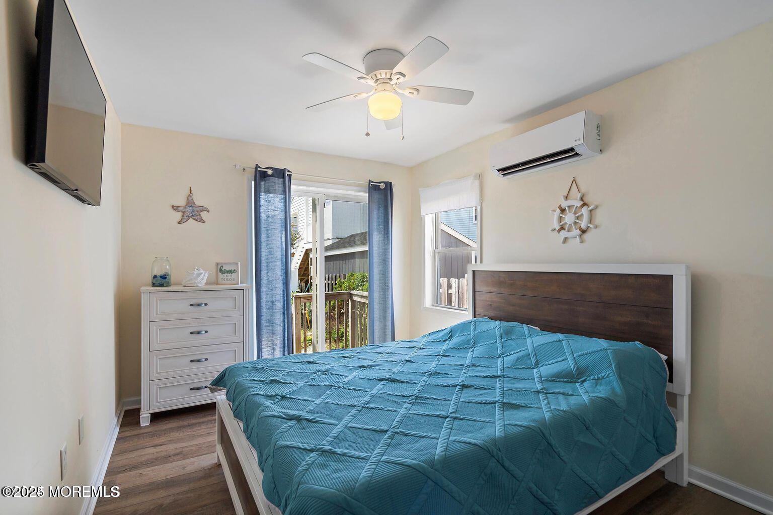 115-117 Coolidge Avenue Seaside Heights, NJ 08751 - Photo 15 of 25 a bedroom with a bed and a chandelier