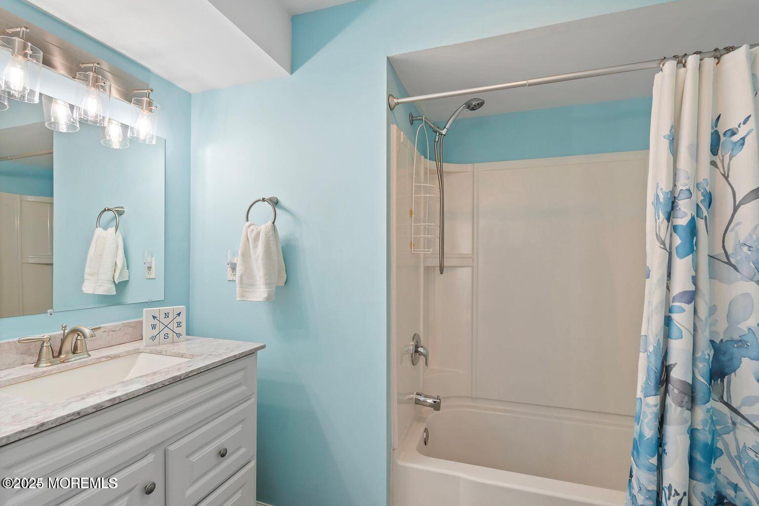 115-117 Coolidge Avenue Seaside Heights, NJ 08751 - Photo 17 of 25 a bathroom with a granite countertop sink a mirror a shower and a bathtub