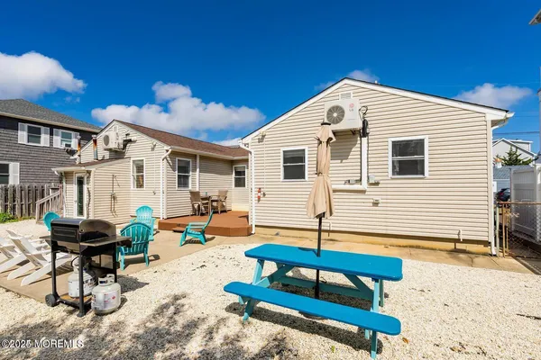 a backyard of a house with barbeque oven table and chairs