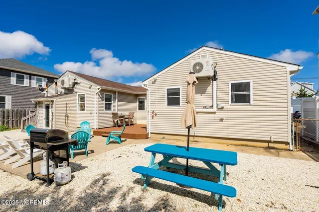 a backyard of a house with barbeque oven table and chairs