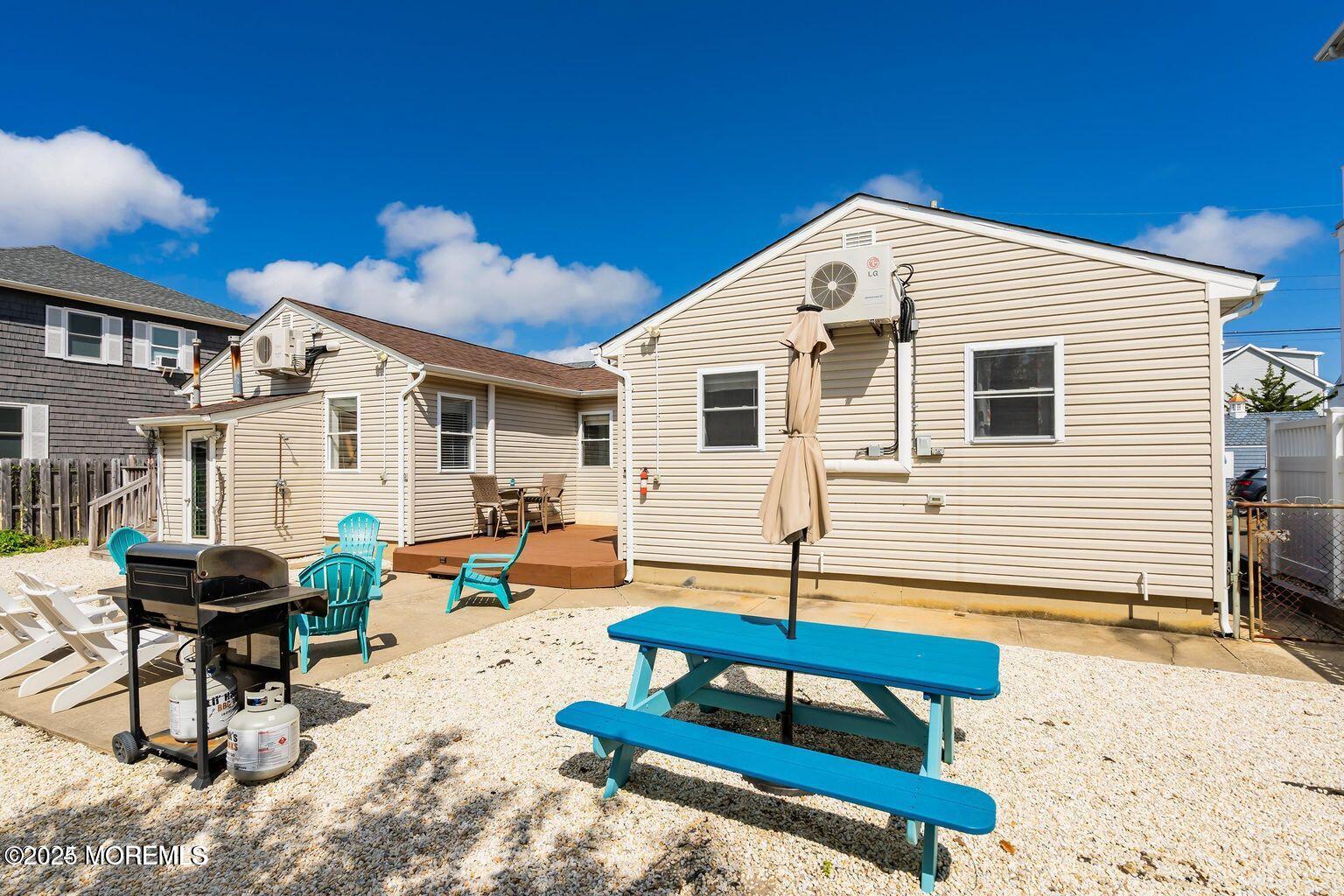 115-117 Coolidge Avenue Seaside Heights, NJ 08751 - Photo 21 of 25 a backyard of a house with barbeque oven table and chairs