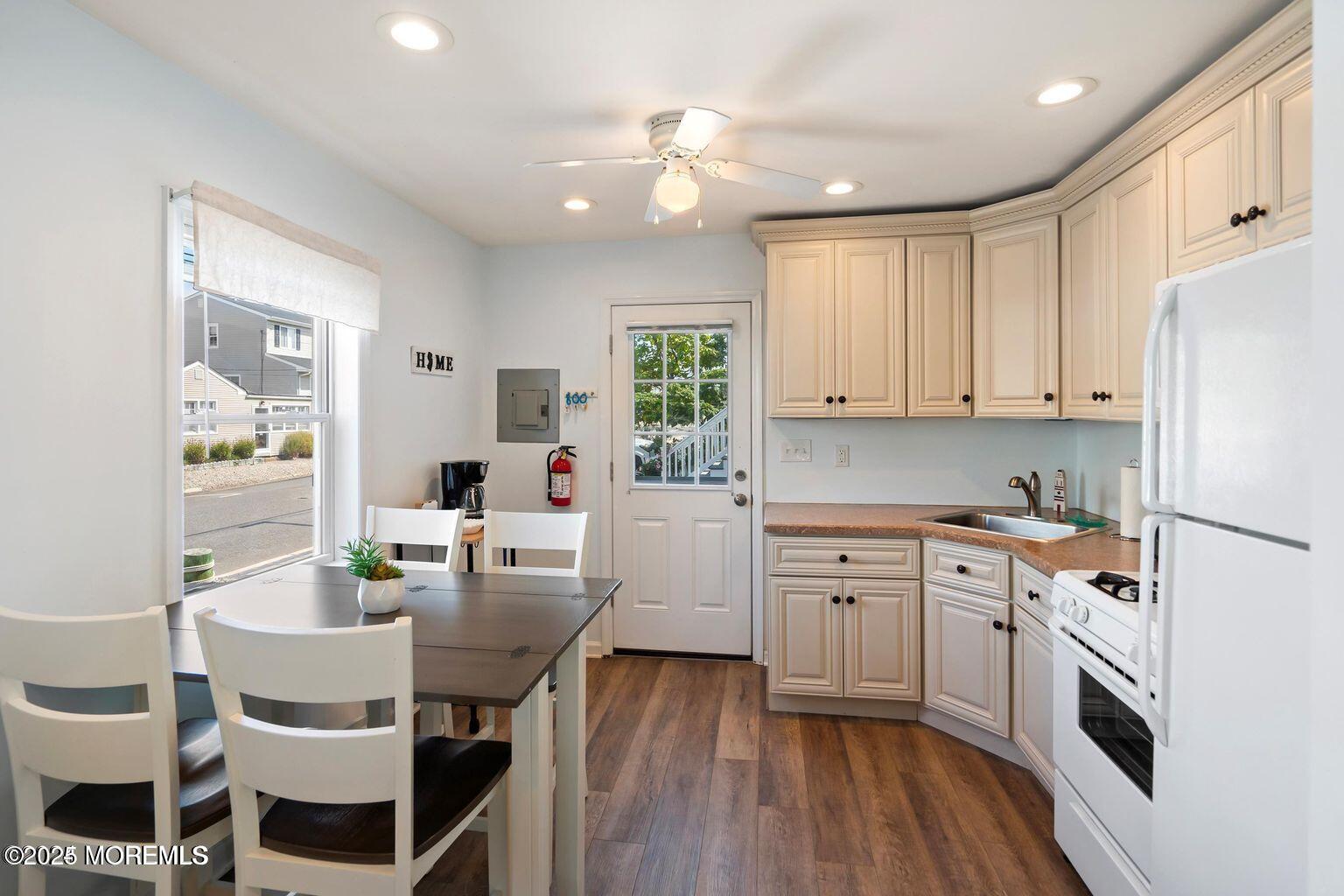 115-117 Coolidge Avenue Seaside Heights, NJ 08751 - Photo 6 of 25 a kitchen with a white cabinets and white appliances