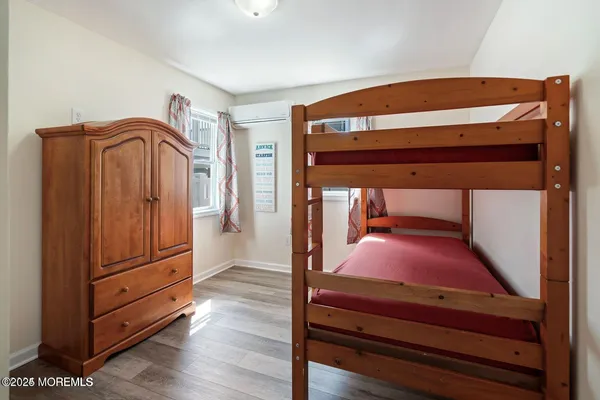 a bedroom with a bunk bed and a dresser