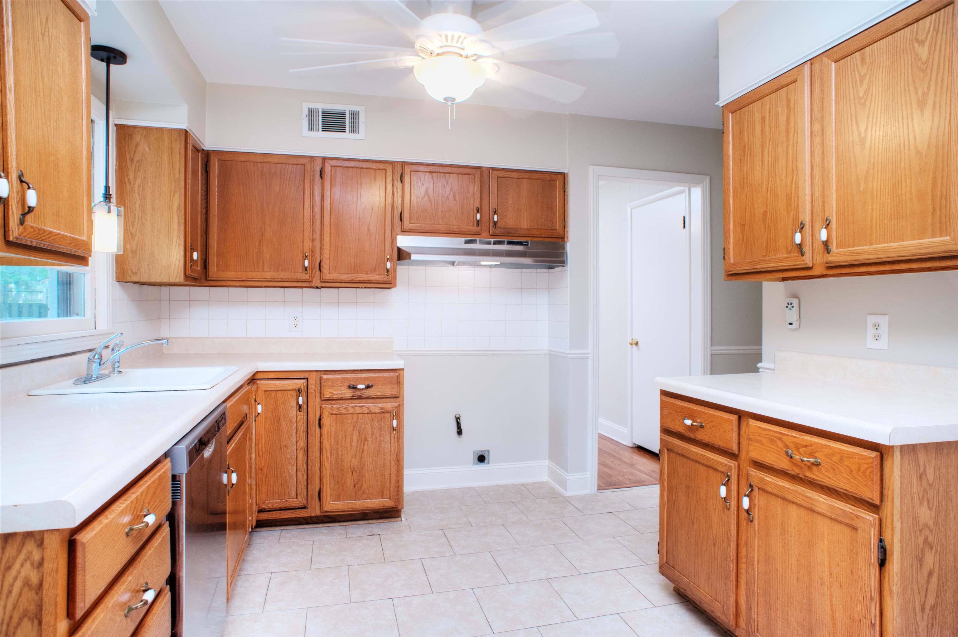 5221 Sequoia Road Memphis, TN 38120 - Photo 6 of 20 a kitchen with stainless steel appliances granite countertop a sink stove and cabinets