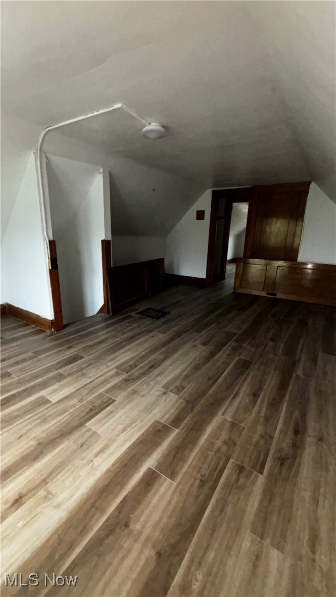 13421 Ashburton Road Cleveland, OH 44110 - Photo 23 of 28 Additional living space with wood-type flooring and vaulted ceiling