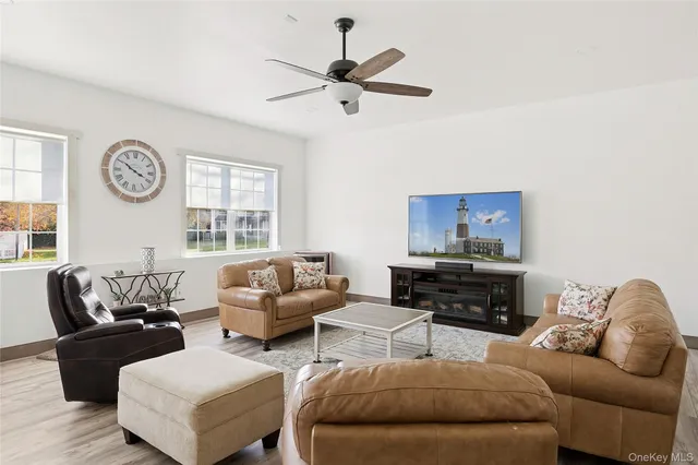 a view of a dining room with furniture a chandelier and wooden floor