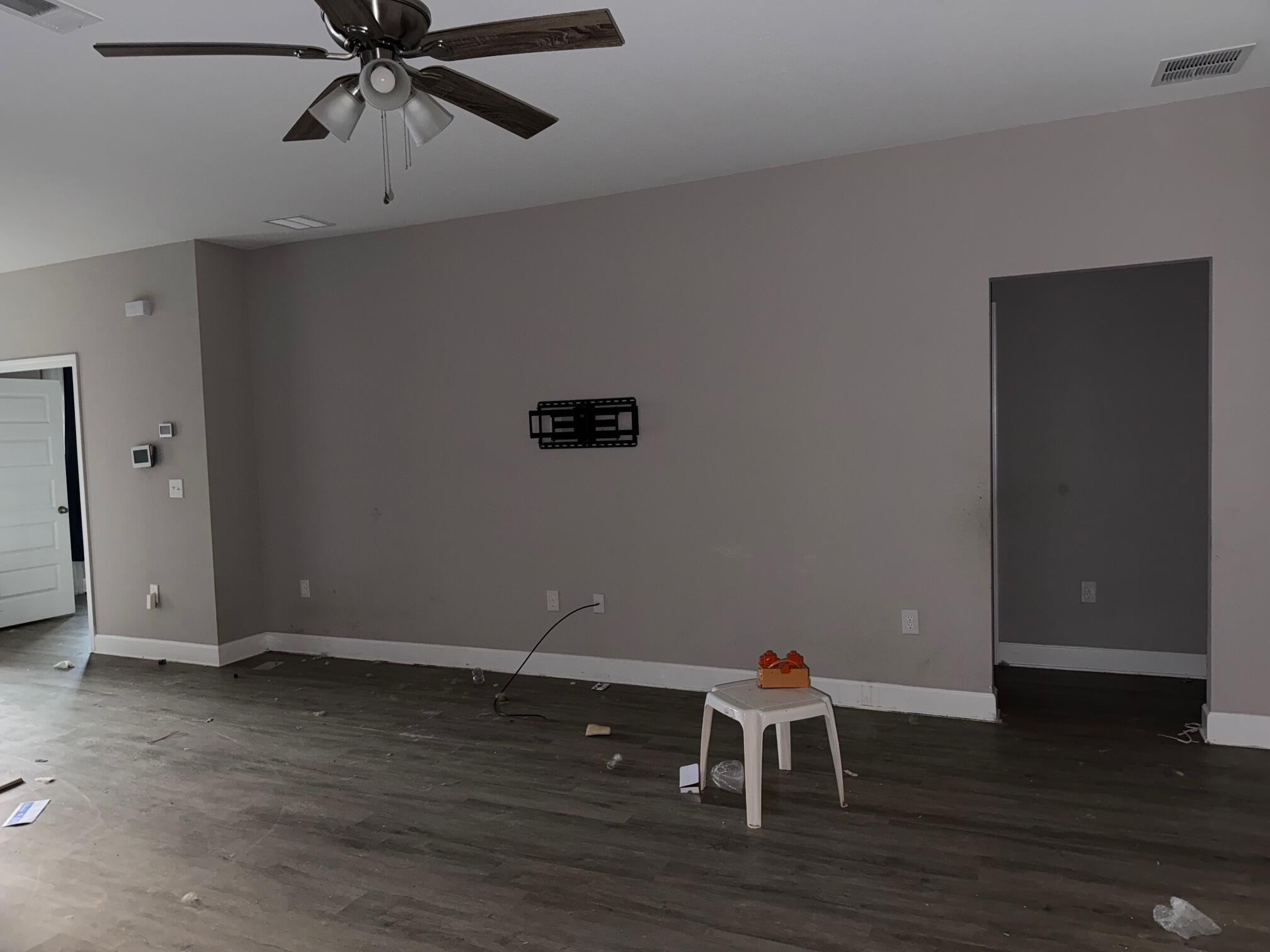1509 Long Needle Court Baker, FL 32531 - Photo 3 of 14 a view of a room with wooden floor and ceiling fan