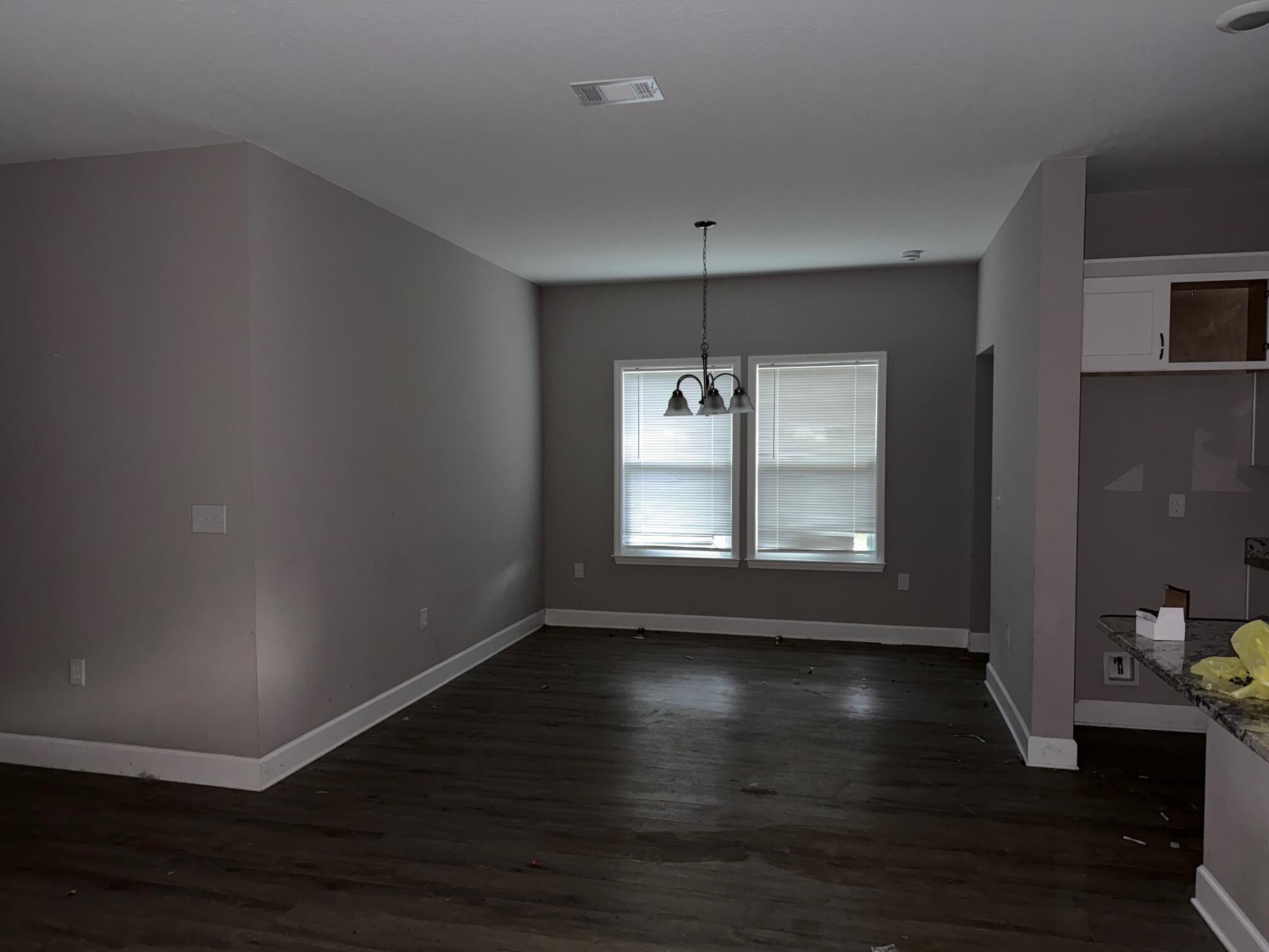 1509 Long Needle Court Baker, FL 32531 - Photo 5 of 14 a view of an empty room with wooden floor and a window