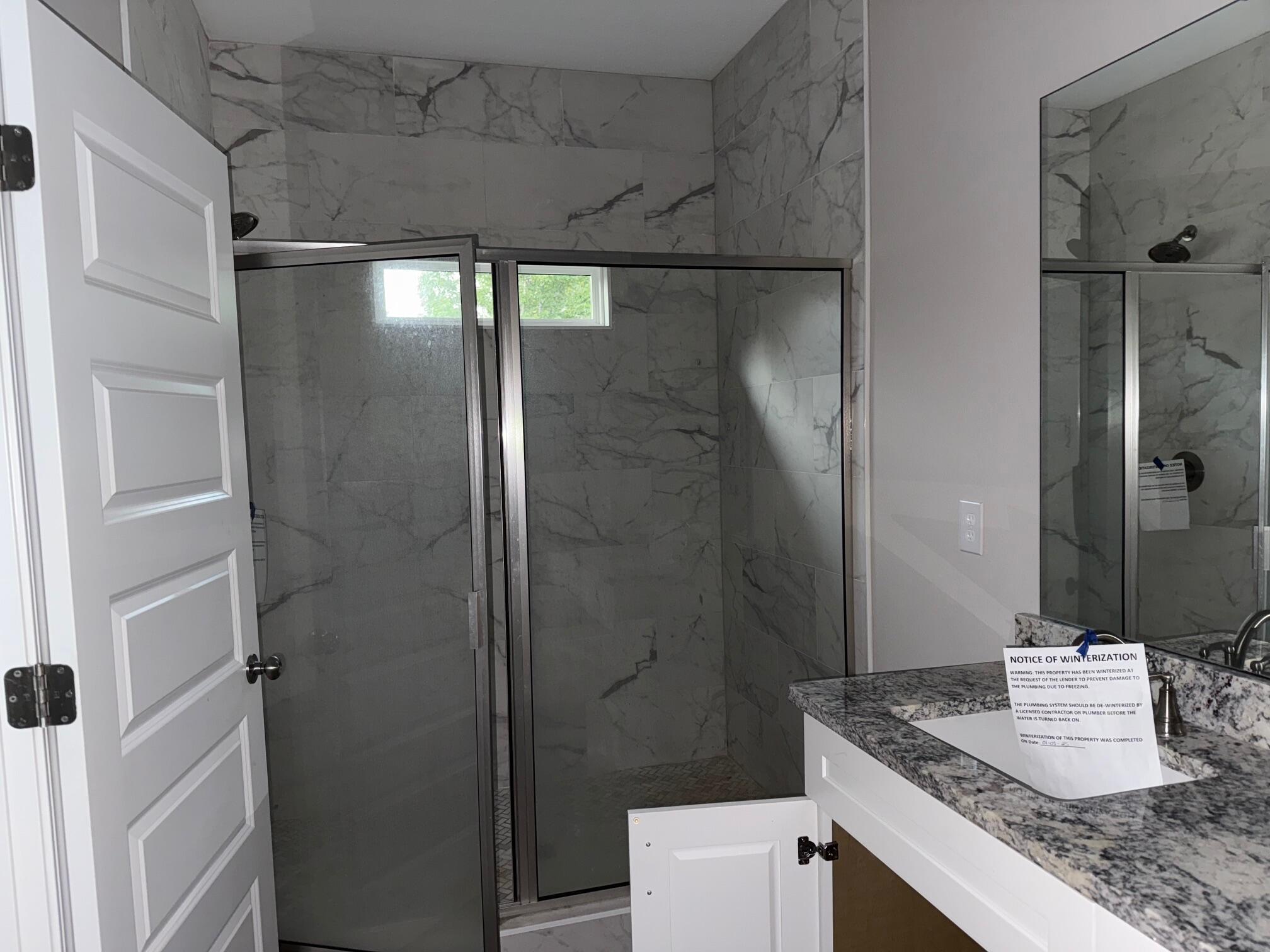 1509 Long Needle Court Baker, FL 32531 - Photo 8 of 14 a bathroom with a granite countertop shower and a sink