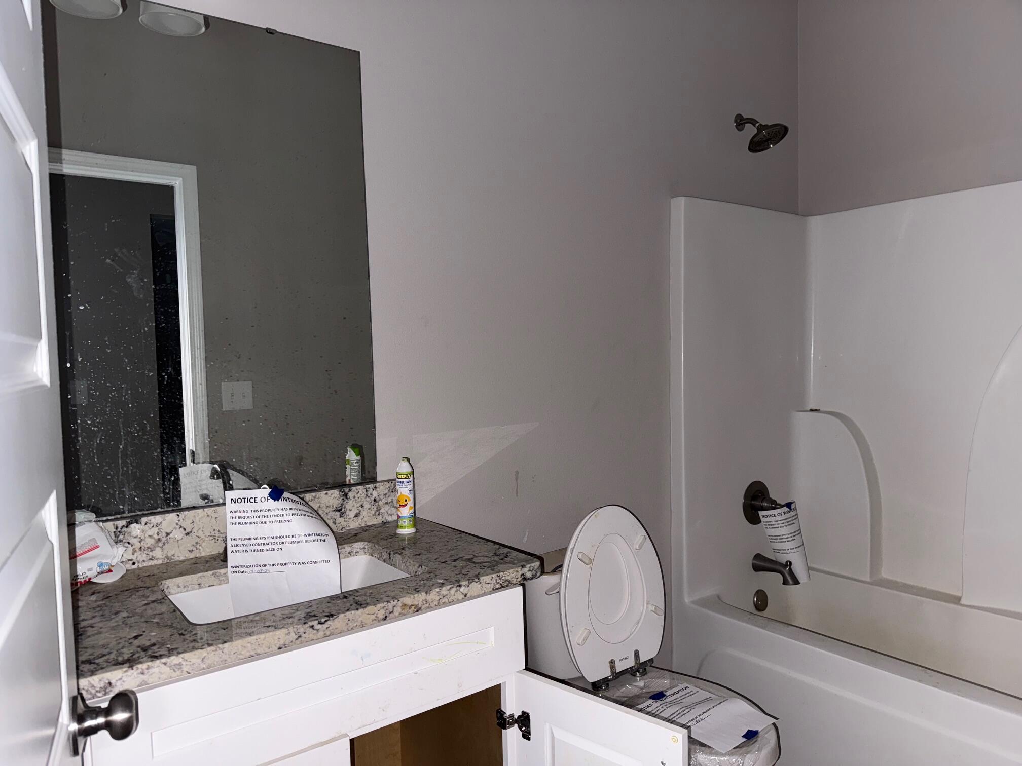 1509 Long Needle Court Baker, FL 32531 - Photo 10 of 14 a bathroom with a granite countertop sink and a mirror