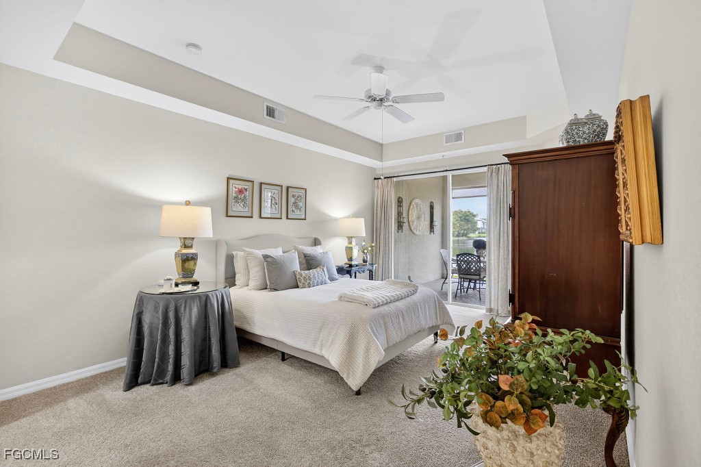 3610 Lansing Loop, Unit 102 Estero, FL 33928 - Photo 13 of 27 a bedroom with a bed and a chandelier