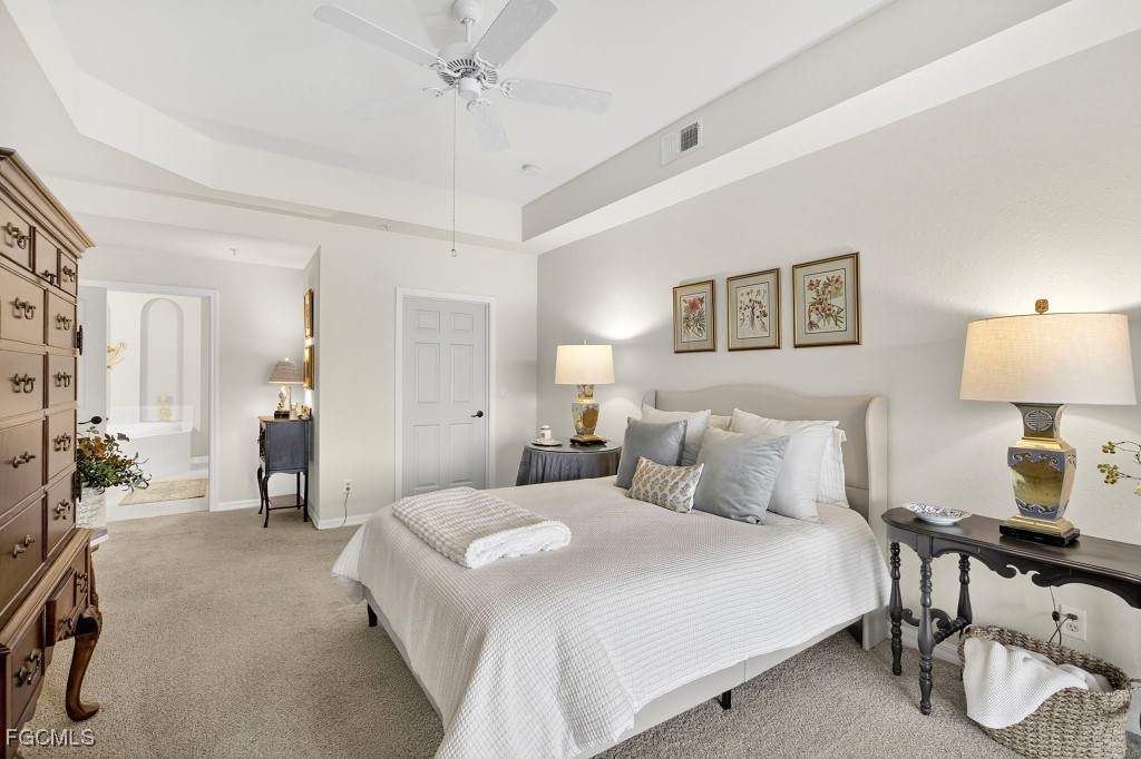 3610 Lansing Loop, Unit 102 Estero, FL 33928 - Photo 14 of 27 a bedroom with a bed and a lamp