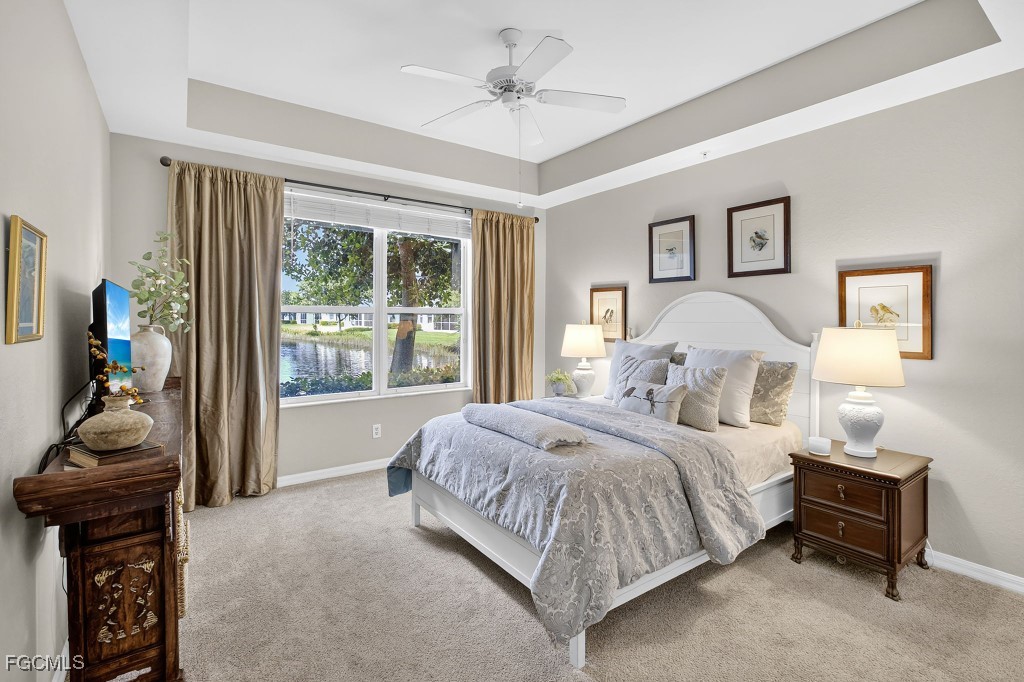 3610 Lansing Loop, Unit 102 Estero, FL 33928 - Photo 18 of 27 a bedroom with a bed and a chandelier