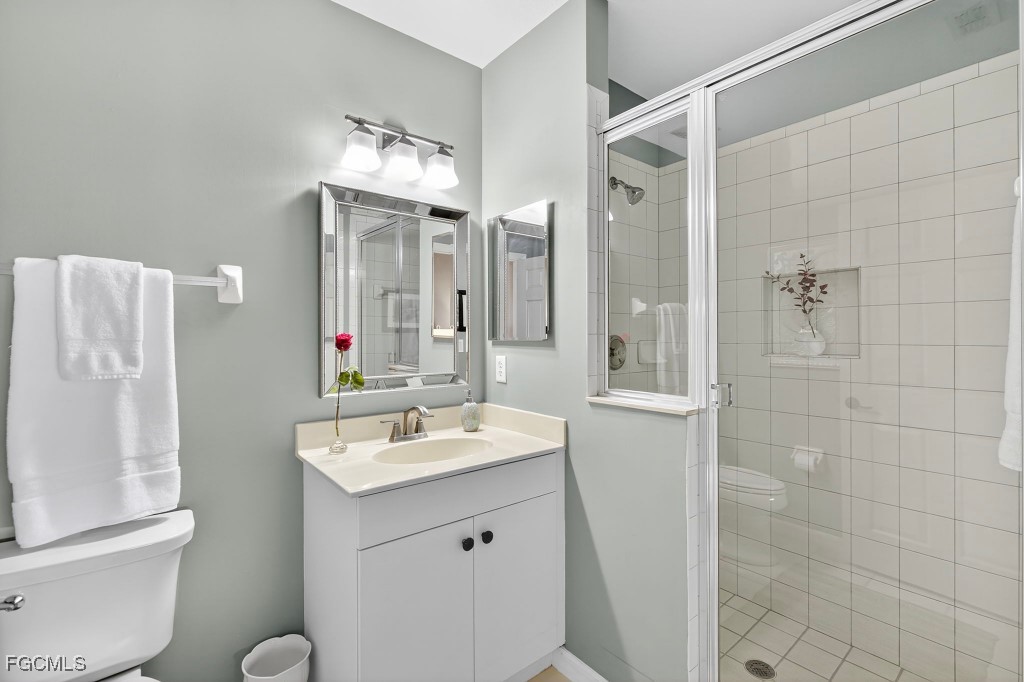 3610 Lansing Loop, Unit 102 Estero, FL 33928 - Photo 19 of 27 a bathroom with a double vanity sink mirror and toilet