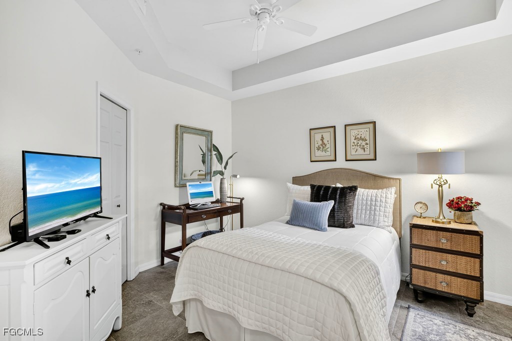 3610 Lansing Loop, Unit 102 Estero, FL 33928 - Photo 20 of 27 a bedroom with a bed and a flat screen tv