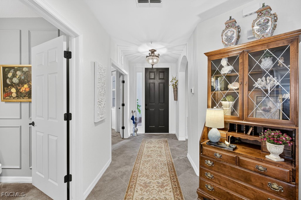 3610 Lansing Loop, Unit 102 Estero, FL 33928 - Photo 2 of 27 a hallway with two couch and dresser