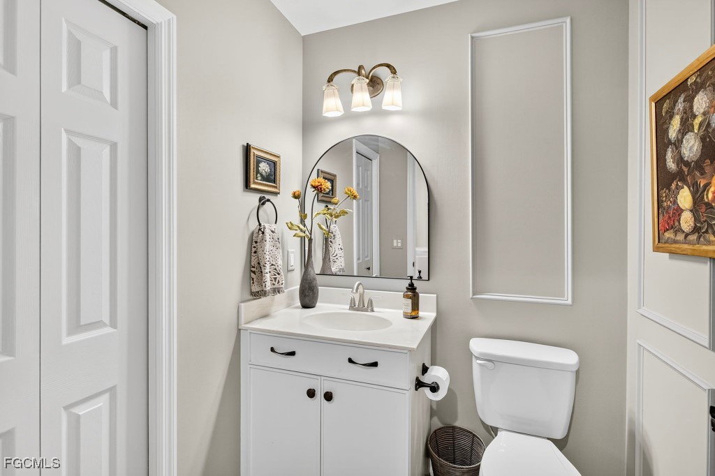 3610 Lansing Loop, Unit 102 Estero, FL 33928 - Photo 21 of 27 a bathroom with a toilet sink and mirror