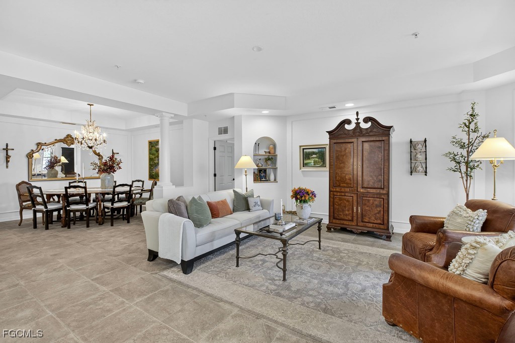 3610 Lansing Loop, Unit 102 Estero, FL 33928 - Photo 5 of 27 a living room with furniture and a chandelier
