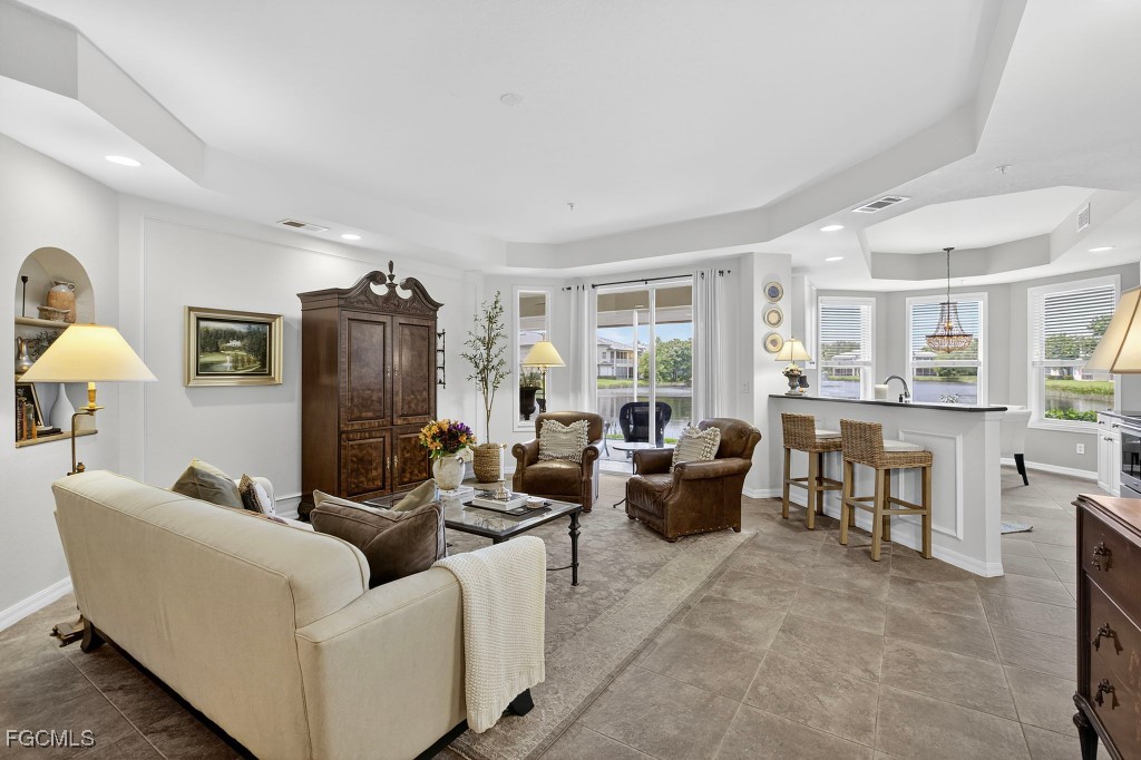 3610 Lansing Loop, Unit 102 Estero, FL 33928 - Photo 6 of 27 a living room with fireplace furniture and a window