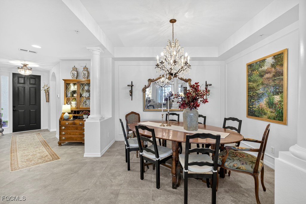 3610 Lansing Loop, Unit 102 Estero, FL 33928 - Photo 8 of 27 a view of a dining room with furniture and chandelier