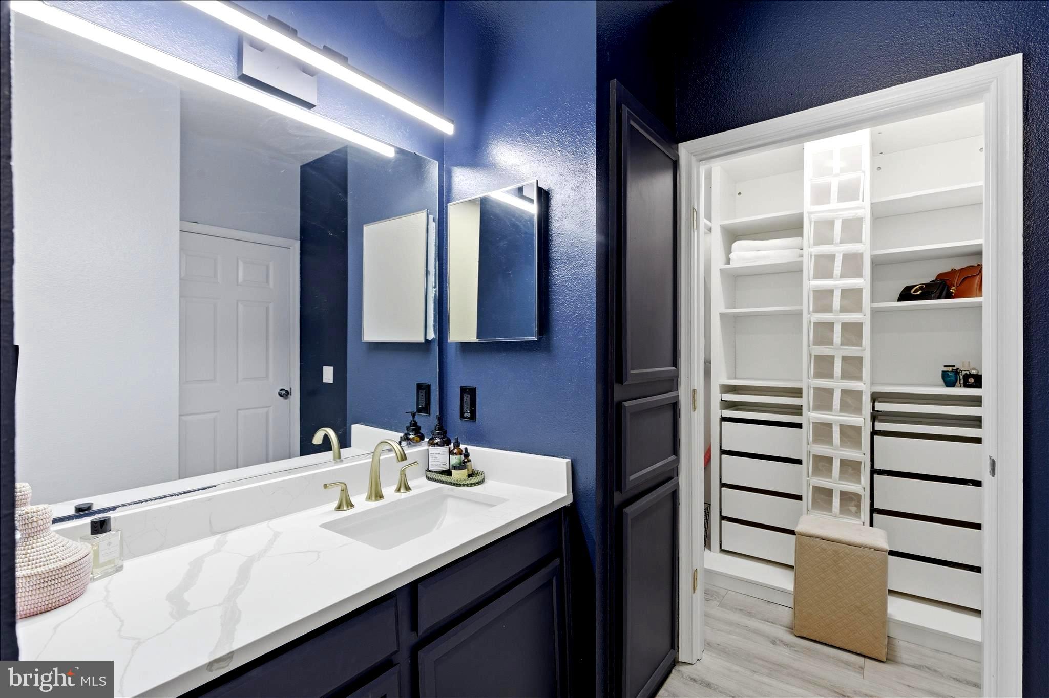 1601 Spring Gate Dr., Unit 1204 McLean, VA 22102 - Photo 15 of 52 a bathroom with a sink and a mirror