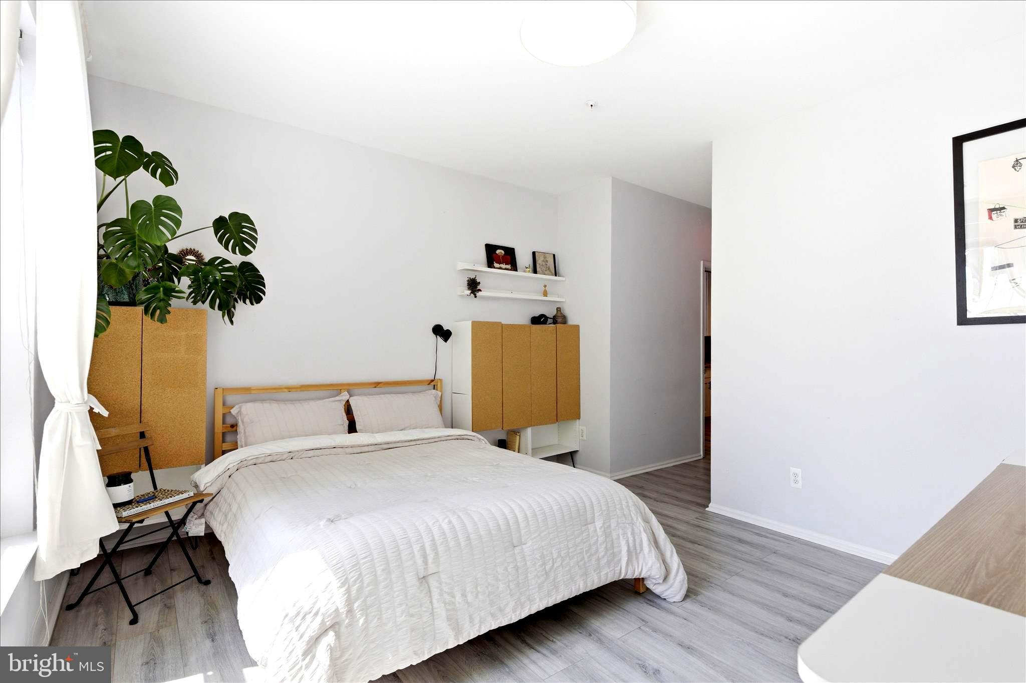 1601 Spring Gate Dr., Unit 1204 McLean, VA 22102 - Photo 18 of 52 a bedroom with a bed and a potted plant