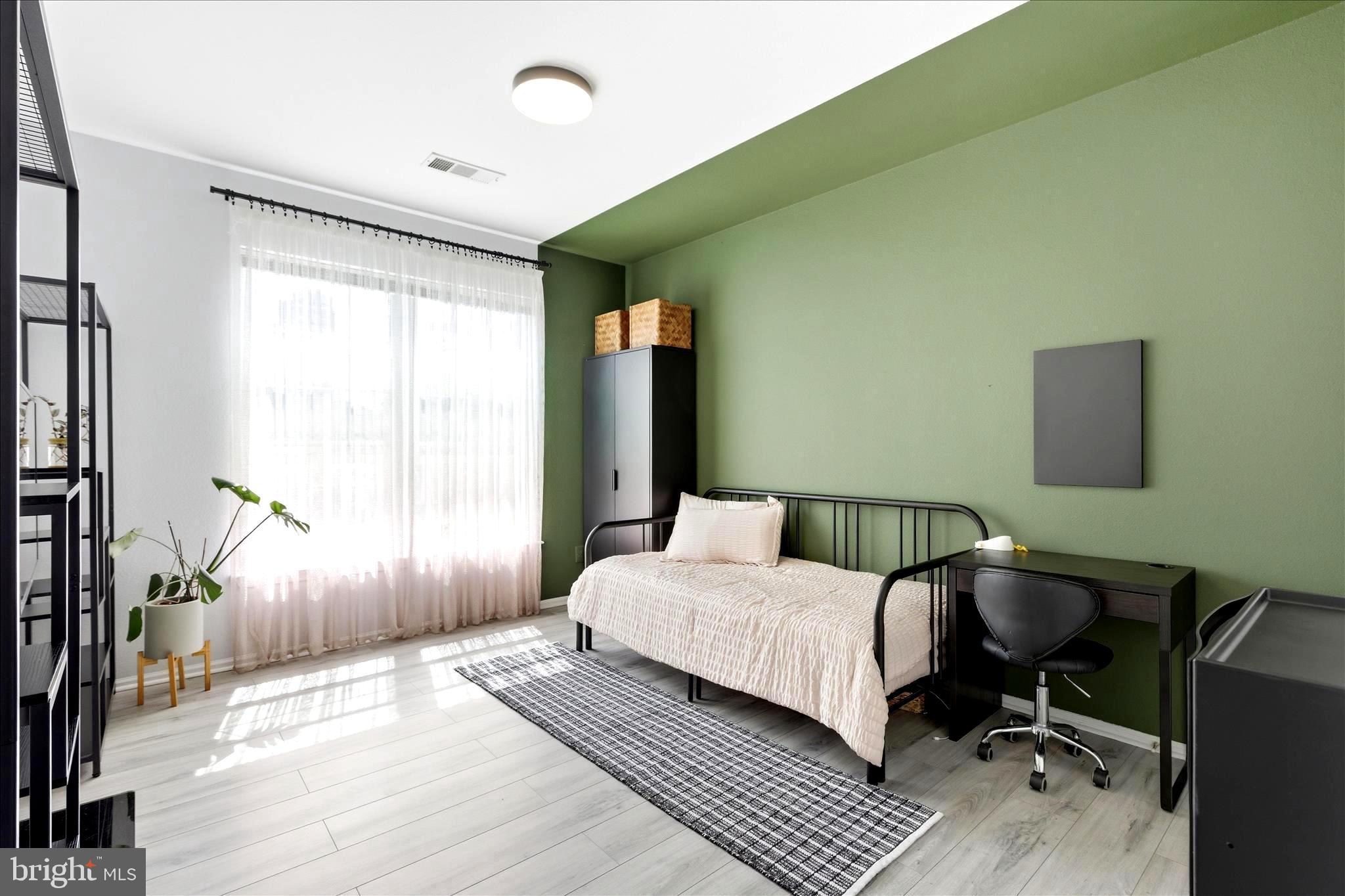 1601 Spring Gate Dr., Unit 1204 McLean, VA 22102 - Photo 19 of 52 a bedroom with a bed and wooden floor