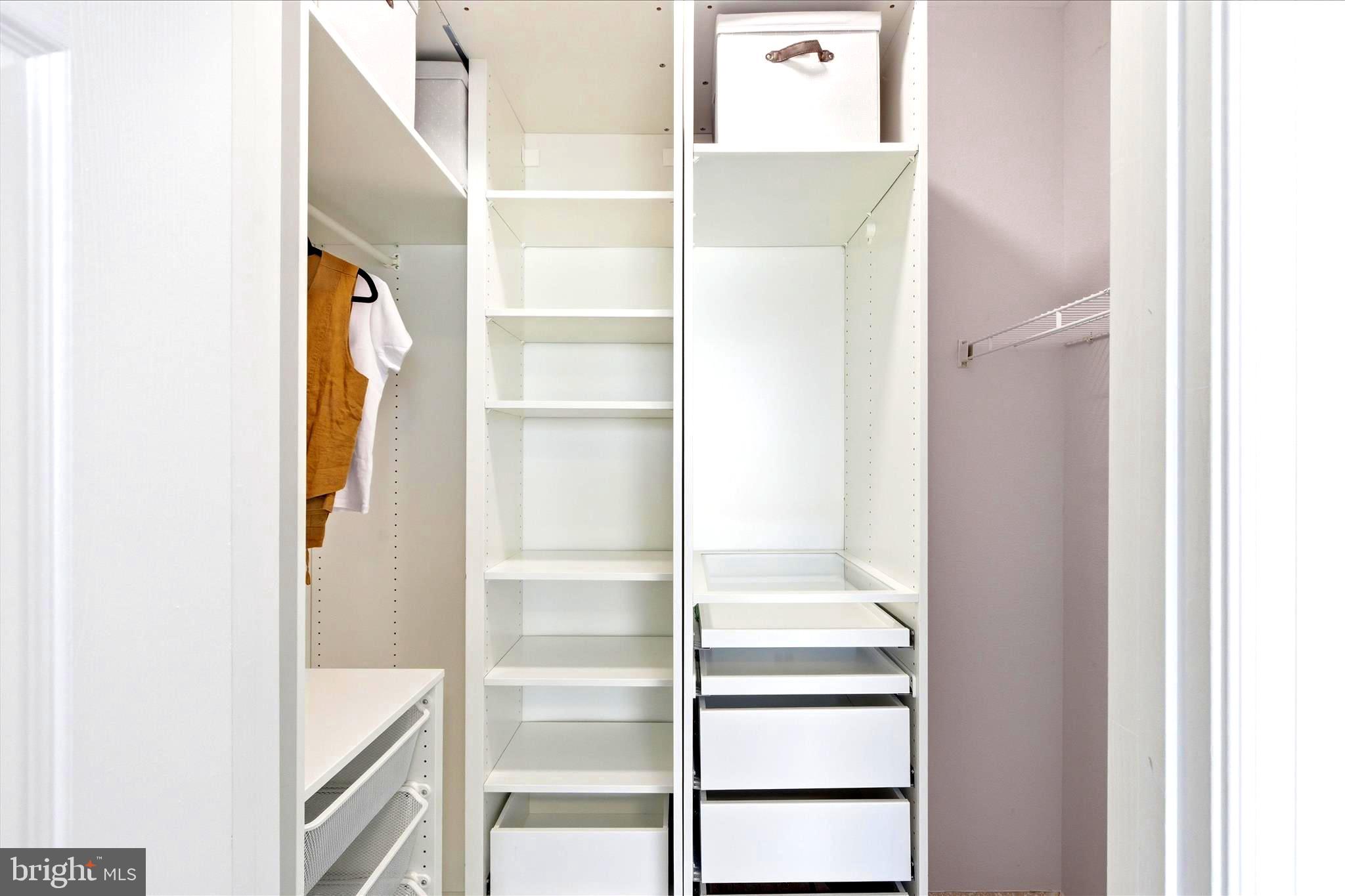 1601 Spring Gate Dr., Unit 1204 McLean, VA 22102 - Photo 21 of 52 a view of an empty walk in closet with empty racks
