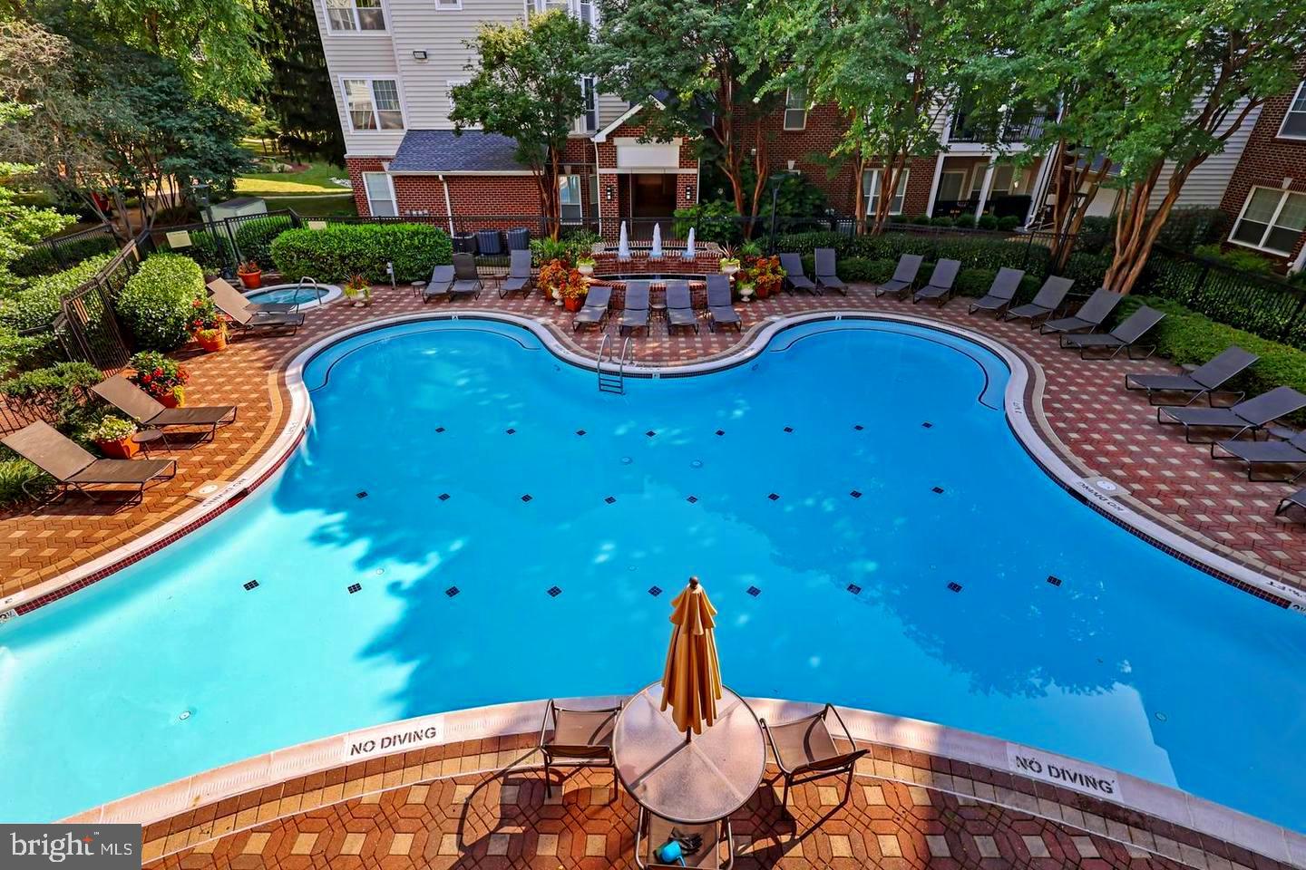 1601 Spring Gate Dr., Unit 1204 McLean, VA 22102 - Photo 37 of 52 a swimming pool with chairs