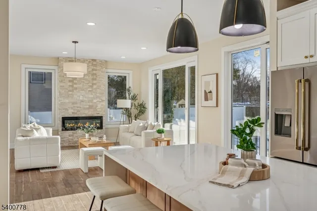 a very nice looking dining room with a couch and a chandelier
