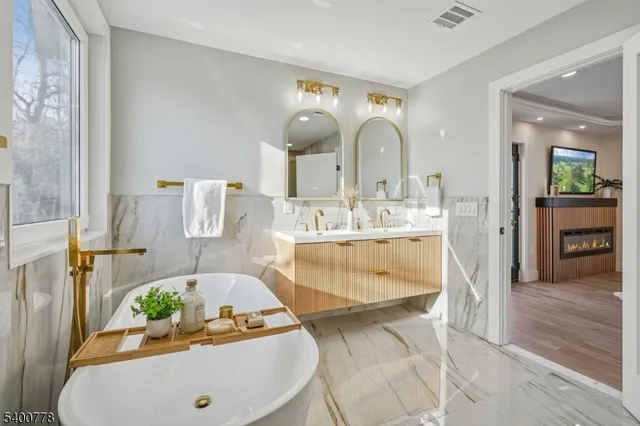 a bathroom with a sink mirror and vanity