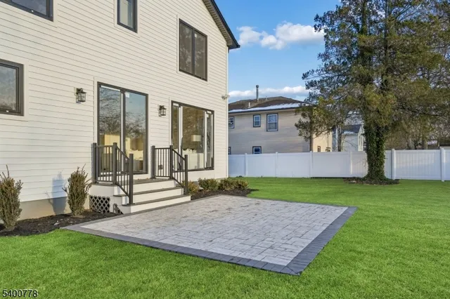 a front view of a house with a garden and plants