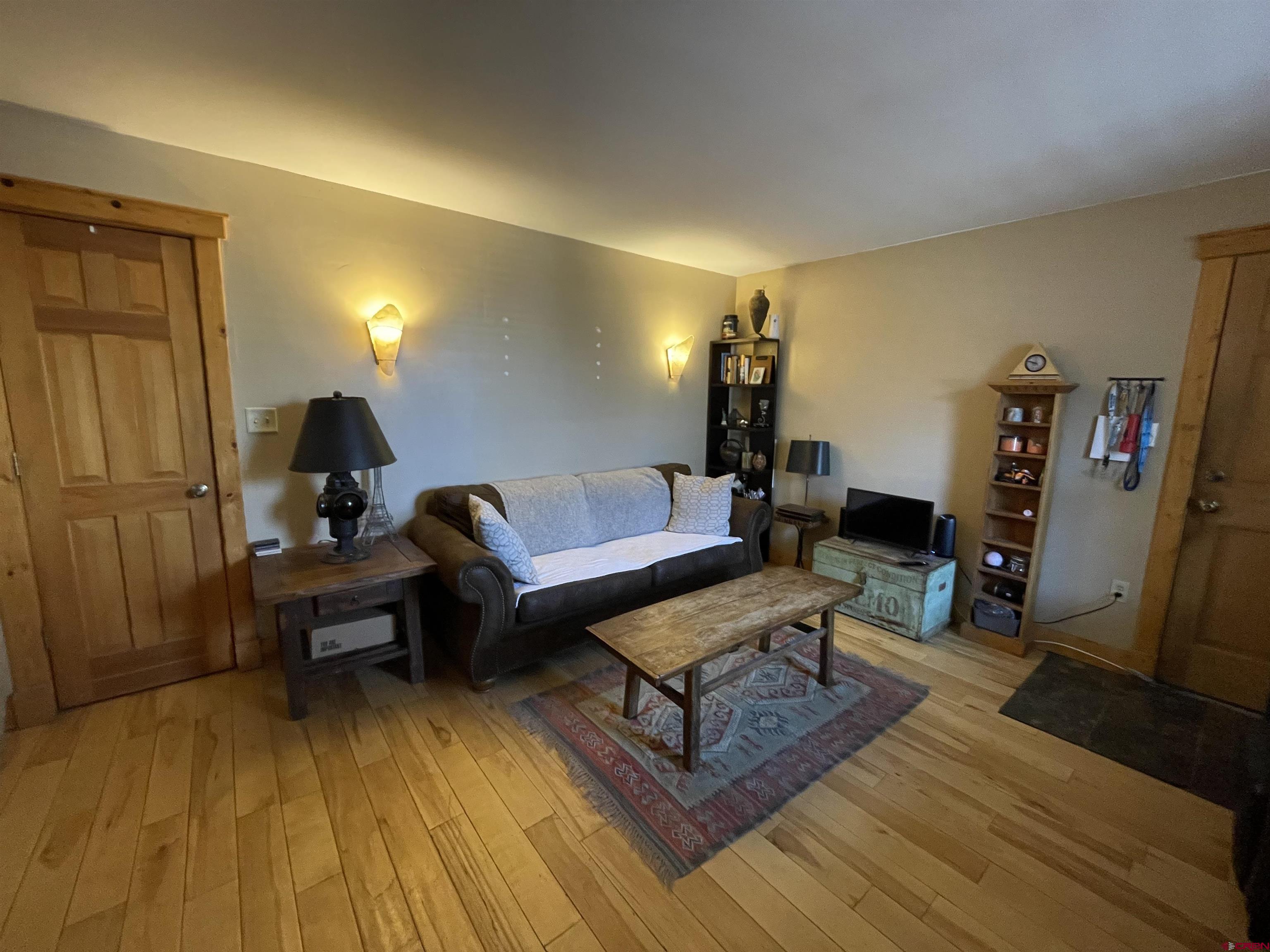 28 Whiterock Avenue, Unit 2 Crested Butte, CO 81224 - Photo 1 of 31 a living room with furniture and a wooden floor