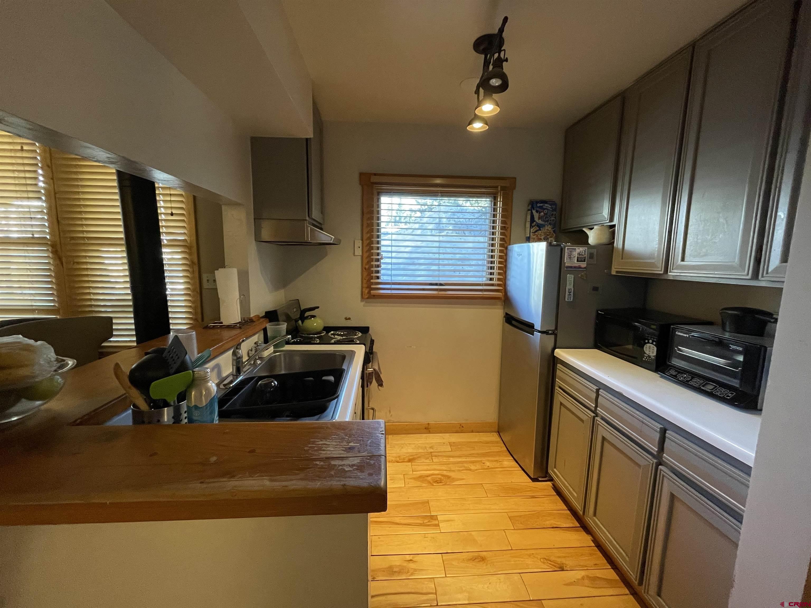 28 Whiterock Avenue, Unit 2 Crested Butte, CO 81224 - Photo 11 of 31 a kitchen with stainless steel appliances granite countertop a sink and a stove