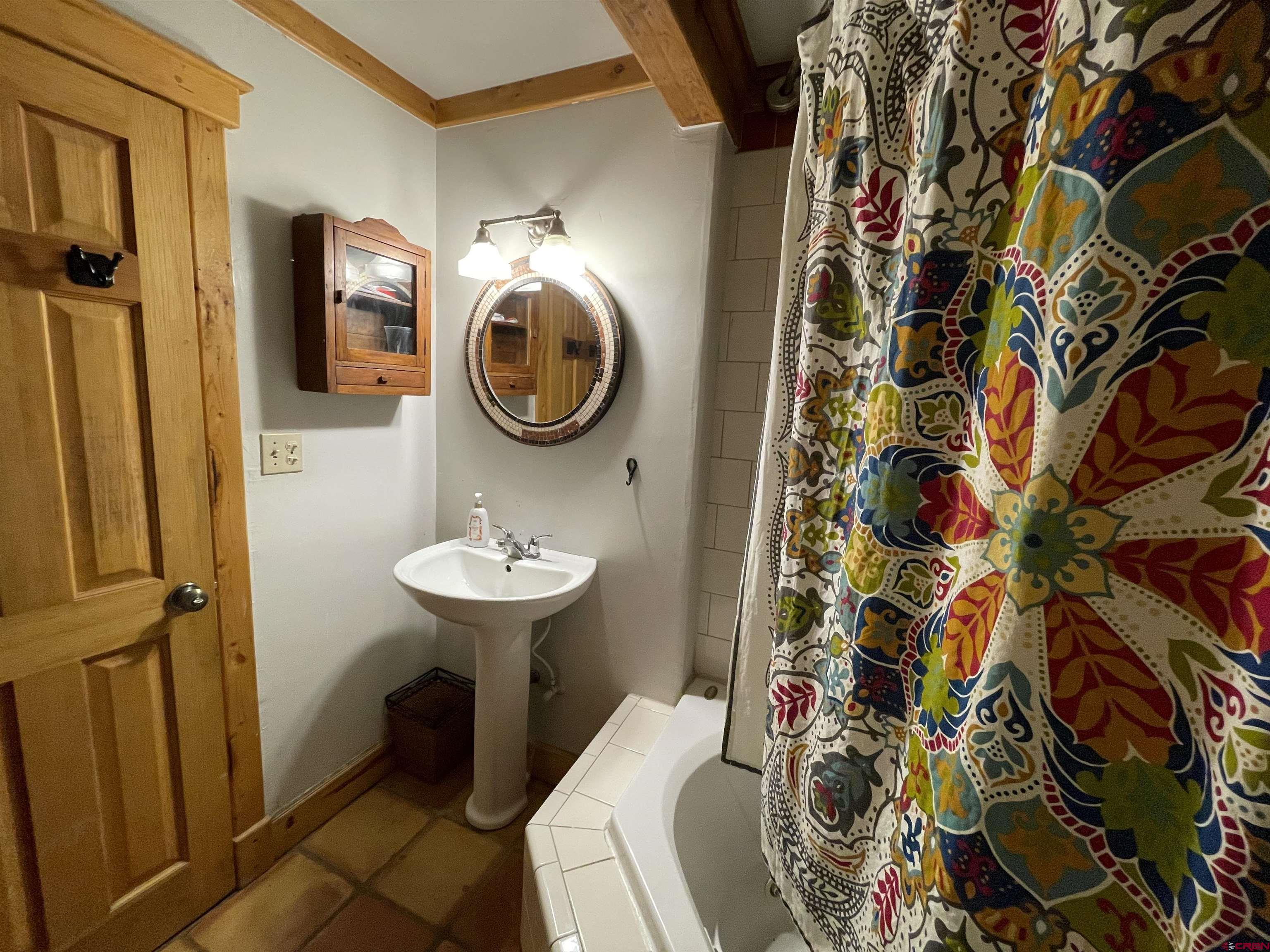 28 Whiterock Avenue, Unit 2 Crested Butte, CO 81224 - Photo 13 of 31 a bathroom with a sink and mirror with toilet