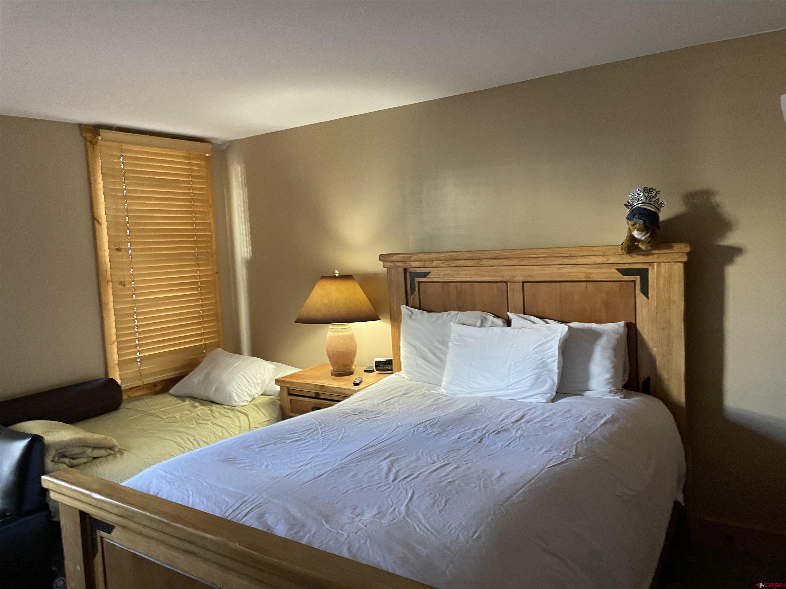 28 Whiterock Avenue, Unit 2 Crested Butte, CO 81224 - Photo 14 of 31 a bedroom with a bed and a lamp