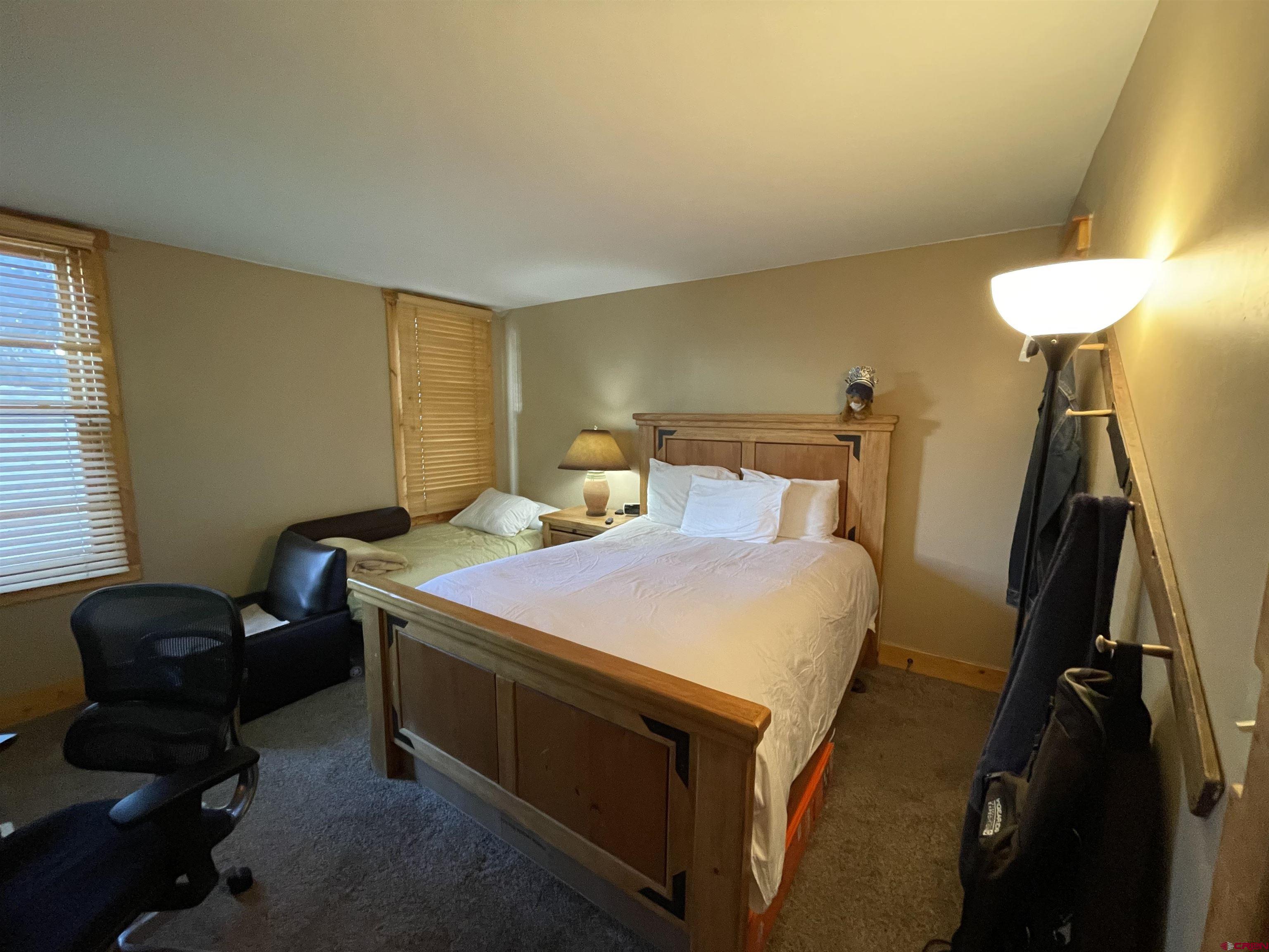 28 Whiterock Avenue, Unit 2 Crested Butte, CO 81224 - Photo 15 of 31 a bedroom with a bed and a chair