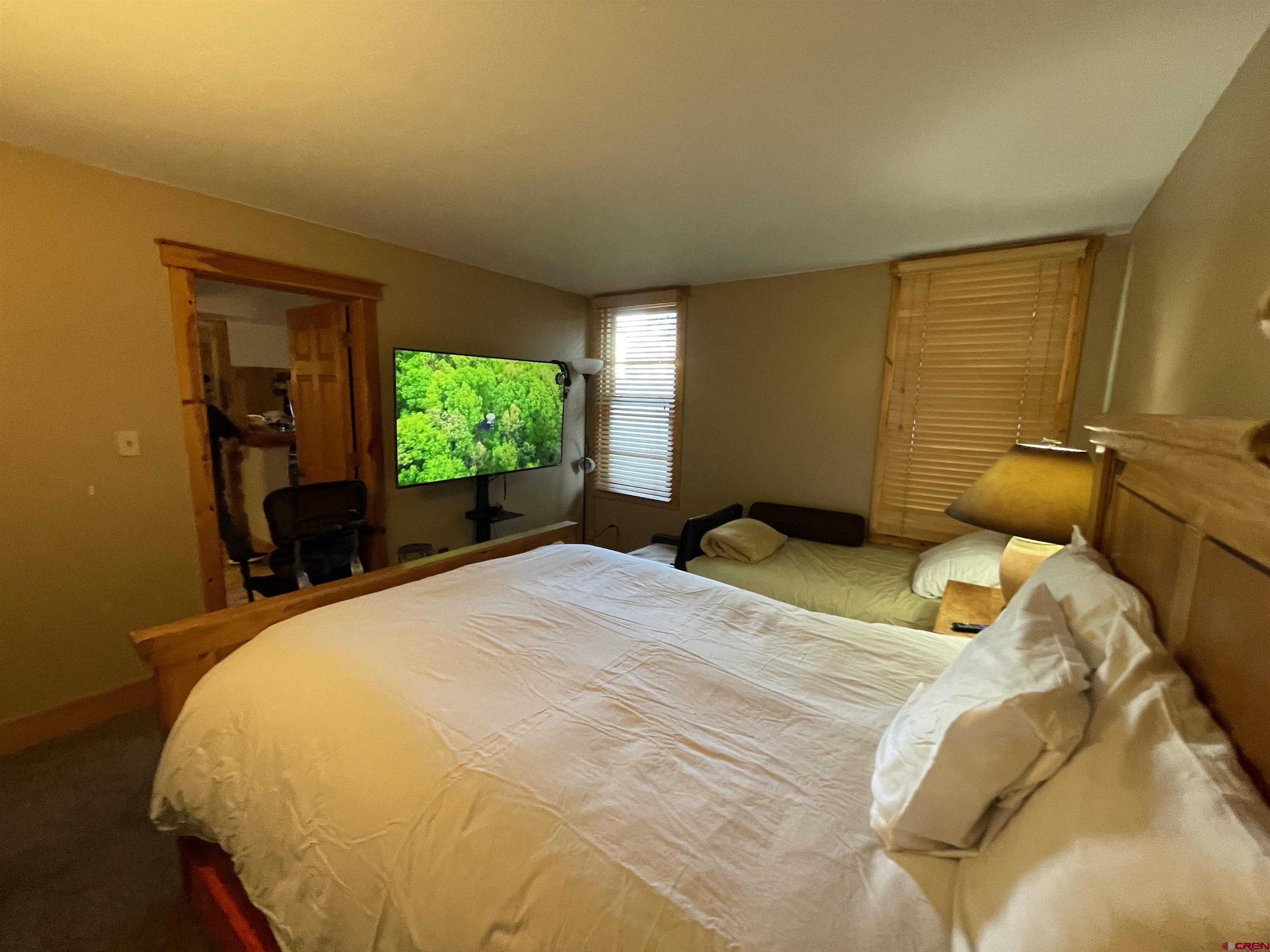 28 Whiterock Avenue, Unit 2 Crested Butte, CO 81224 - Photo 17 of 31 a bedroom with a bed and windows