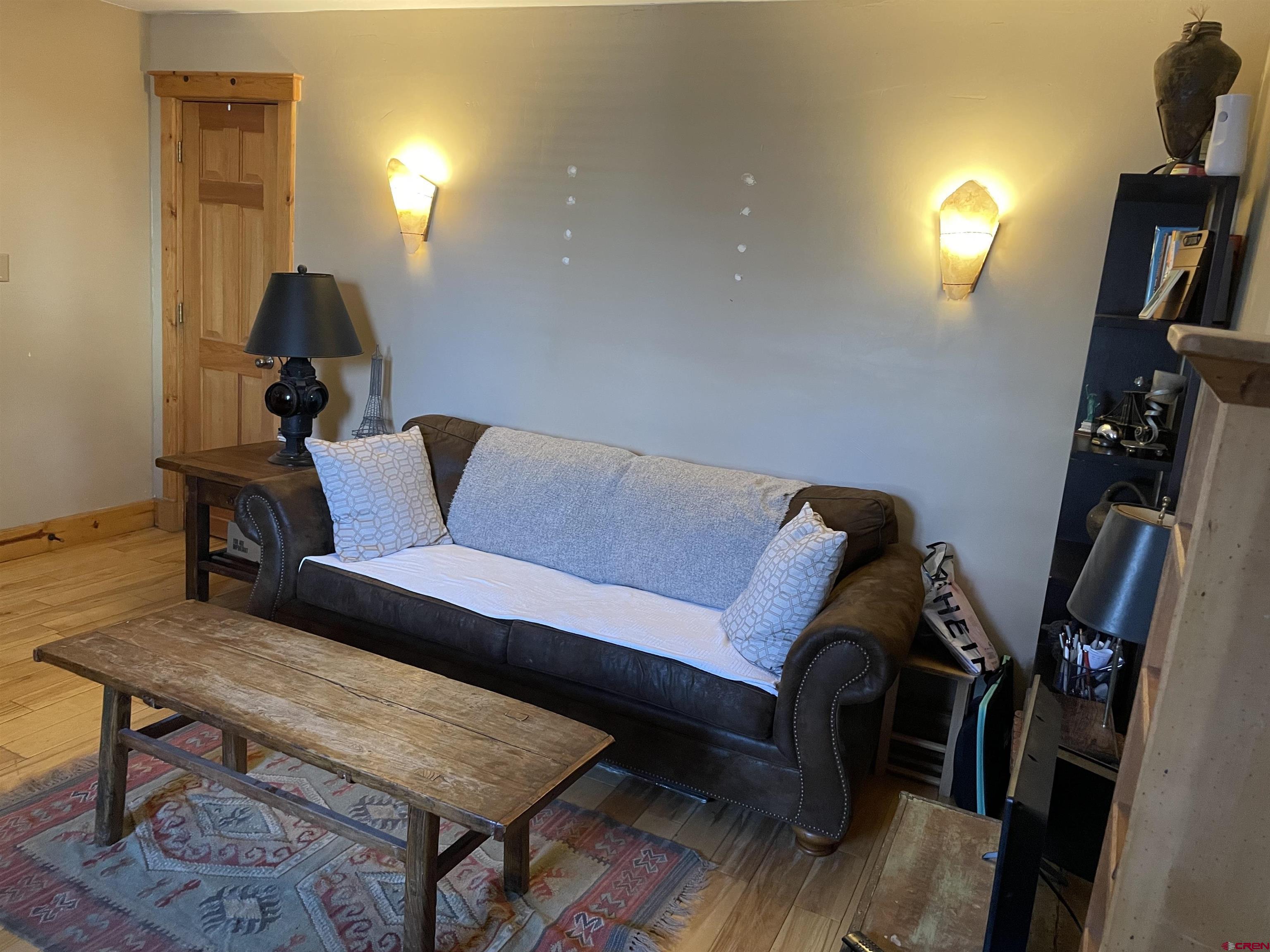 28 Whiterock Avenue, Unit 2 Crested Butte, CO 81224 - Photo 6 of 31 a living room with furniture and a lamp